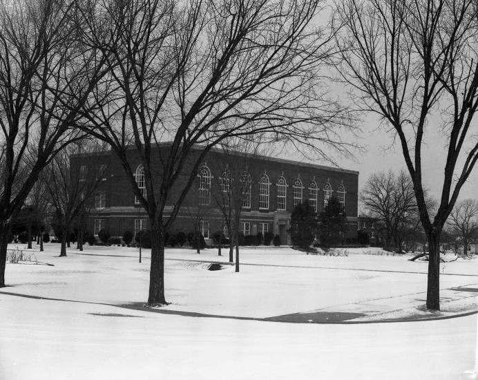 A black 和 white photograph of David Talbot Hall, a brick building with windows on all sides.